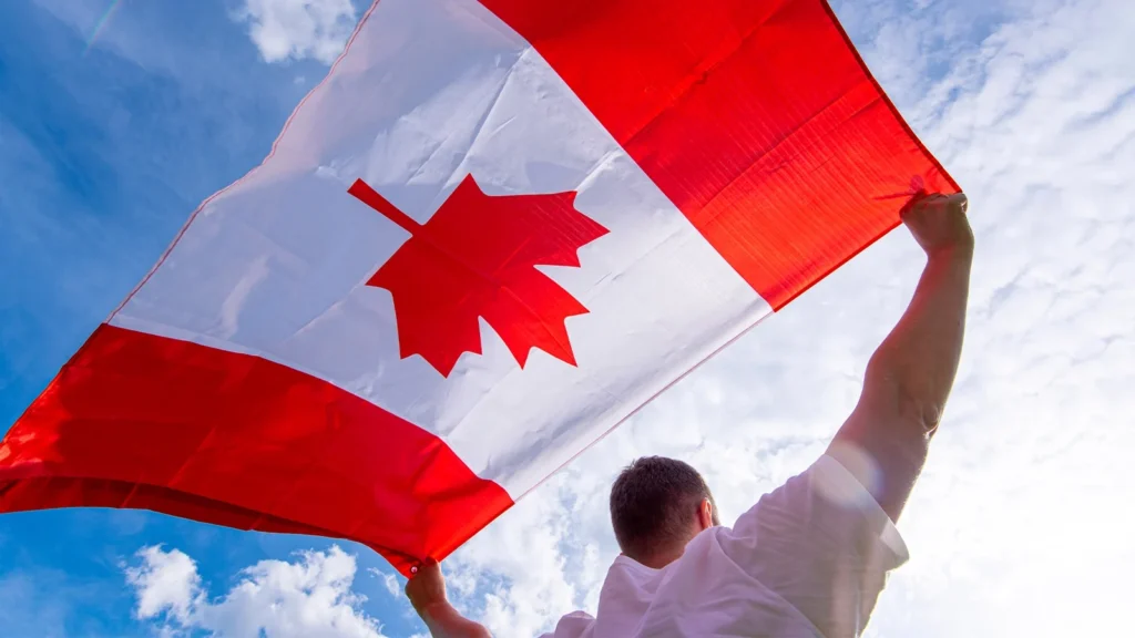 A guy waving Canadian Flag
